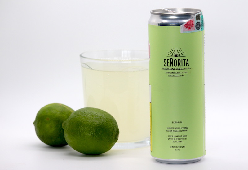 The Mexican Agave, Lime, and Jalapeño drink by Señorita. Pictured is the can, filled glass, and limes.