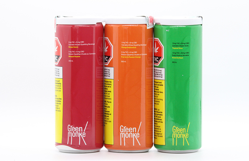 Three Green Monke Drinks in a row, they are red, orange and green.