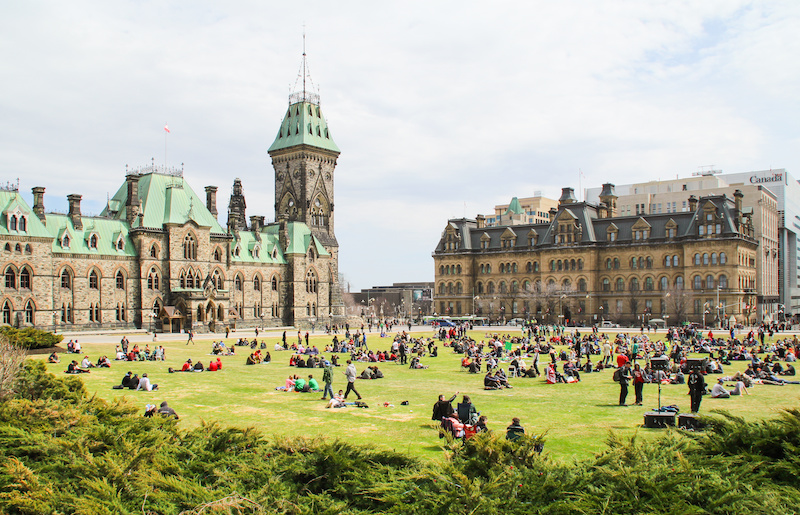 Groups of people gather on 4/20 outside of the Parliament buildings in Ottawa.